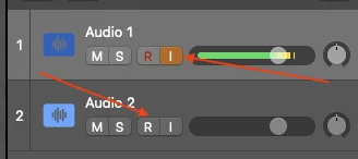 Logic Pro track headers showing Audio 1 with the orange I button lit and a green level meter active, and Audio 2 below it with the red R button armed