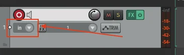 Reaper track header with the small input/source dropdown highlighted; the dropdown sits just below the record-arm circle and reads 'in'.